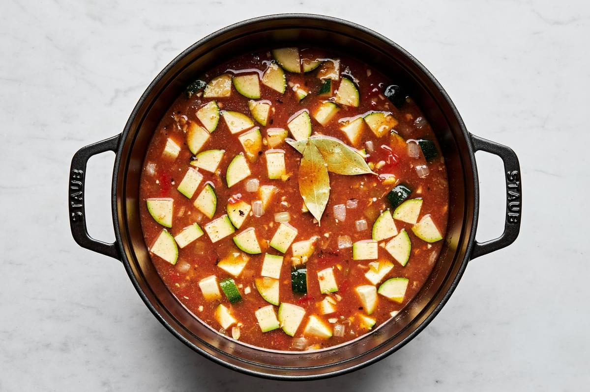 vegetarian tortilla soup made with vegetable stock, creamed corn, tomatoes, enchilada sauce, zucchini and spices in a pot