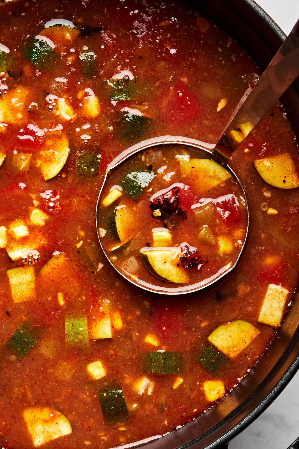vegetarian tortilla soup made with vegetable stock, creamed corn, tomatoes, enchilada sauce, zucchini and spices in a pot