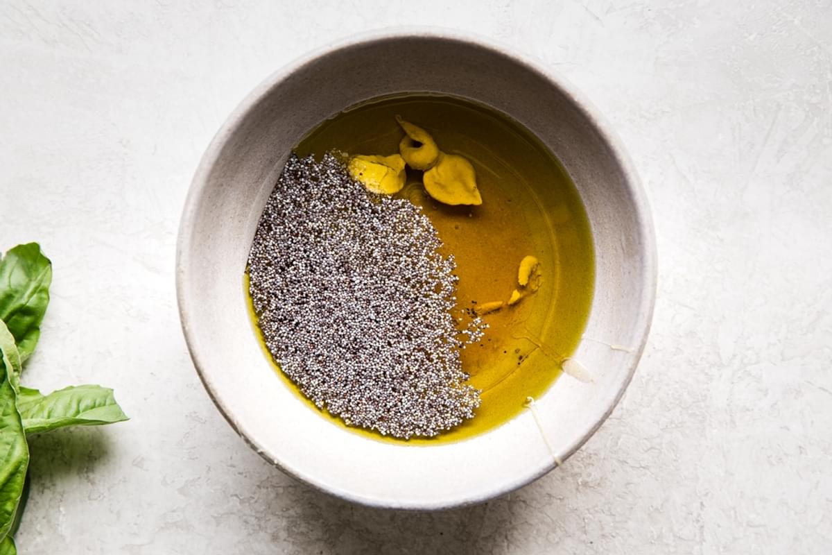 ingredients for poppyseed dressing in a small bowl mustard, olive oil