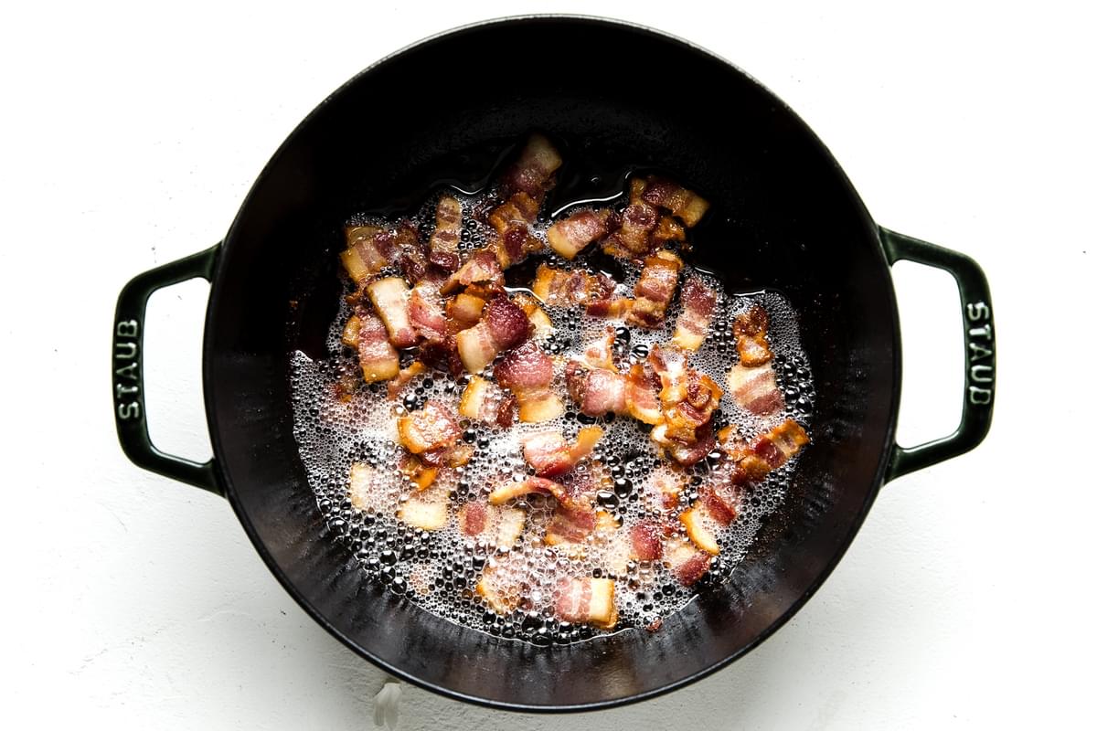 bacon frying in a soup pot