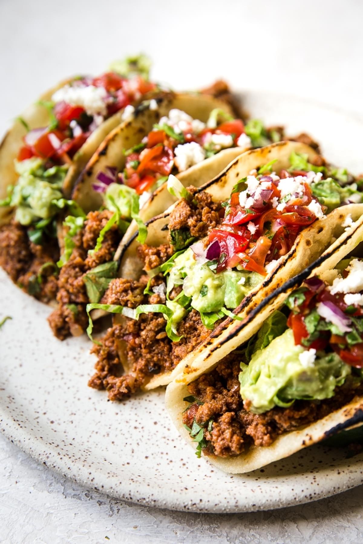 ground beef tacos with guacamole on a plate