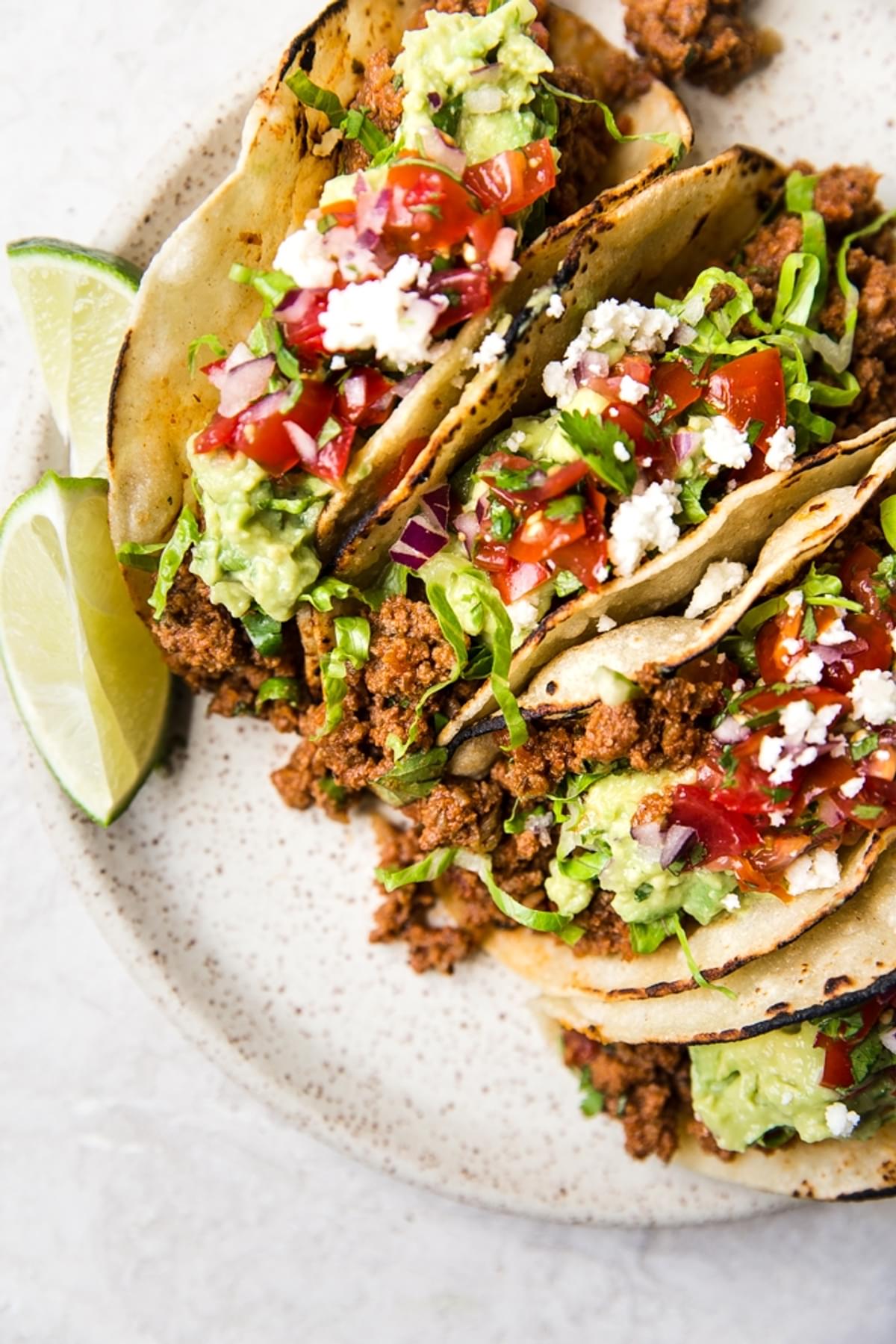 ground beef tacos with guacamole on a plate
