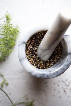 mortar and pestle grinding fresh pickling spices