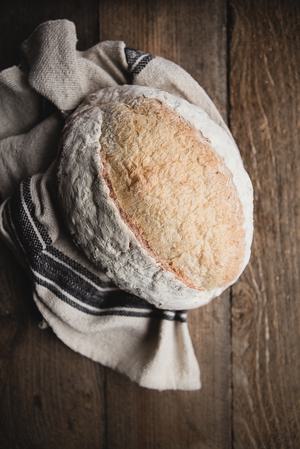 rustic loaf of bread on a linen on the table