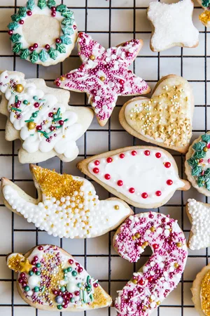Decorated Sour Cream Sugar Cookies With Icing and sprinkles on a baking rack