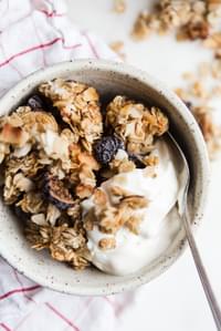 homemade vanilla granola with figs, almonds and coconut flakes in a bowl with yogurt