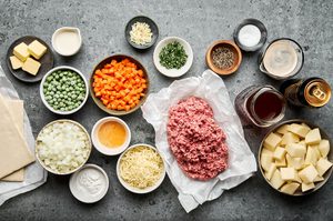 ingredients measured and prepped to make homemade cozy lamb pie with puff pastry bottom topped with mashed potatoes