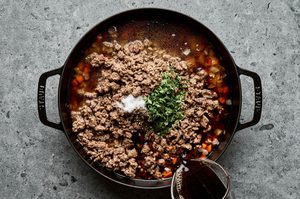 savory ground lamb and veggie filling being made in a skillet to use in savory and comforting lamb pie