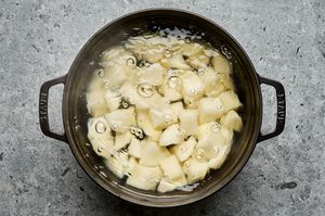 potatoes boiling in water to make creamy mashed potatoes to use on top of ground lamb shepherds pie