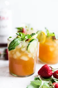 Pimm's Cup cocktail with strawberries, cucumber and basil