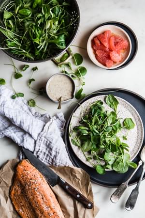 ingredients laid out baked salmon, lettuce, honey mustard dressing, grapefruit
