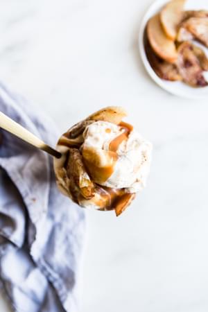 2 salted caramel apple sundaes with vanilla ice cream and a spoons