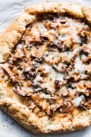 golden brown mushroom galette with melted cheese and herbs