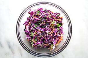 sesame slaw with cilantro, carrots and red cabbage in a bowl