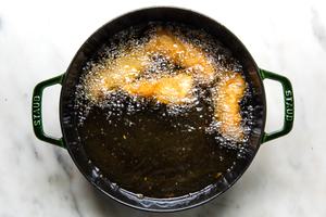 Beer-Battered Fish frying in oil
