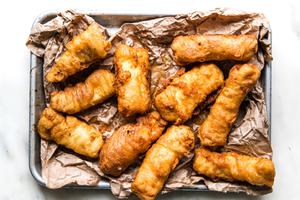 Beer-Battered Fish on parchment paper on a baking sheet