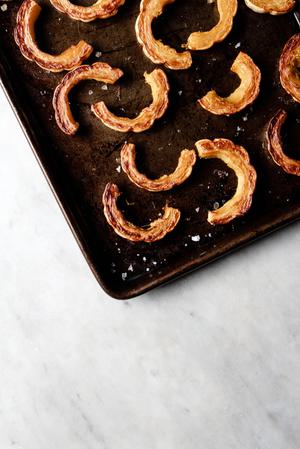 slices of roasted delicata squash on a baking sheet
