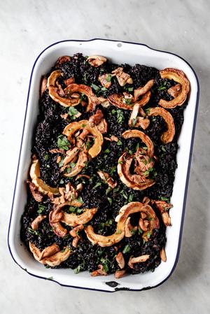 a large pan of forbidden rice Thanksgiving Turkey dressing made with delicata squash and sausage