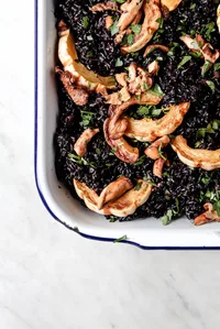 Forbidden rice stuffing with delicata squash in a serving dish