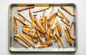baked French fries on a baking sheet