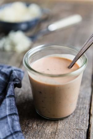 Homemade Russian dressing in a jar with a spoon