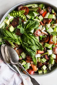 Spring Chopped Salad With Asparagus And Peas on a plate with a serving spoon