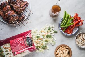 Asian Chopped Salad with Hoisin Marinated Pork Kabab with a salad kit, green and red bell peppers and sesame salad dressing