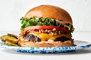 A classic juicy cheese burger topped with secret sauce, melted cheese, caramelized onion, tomato, lettuce and pickles
