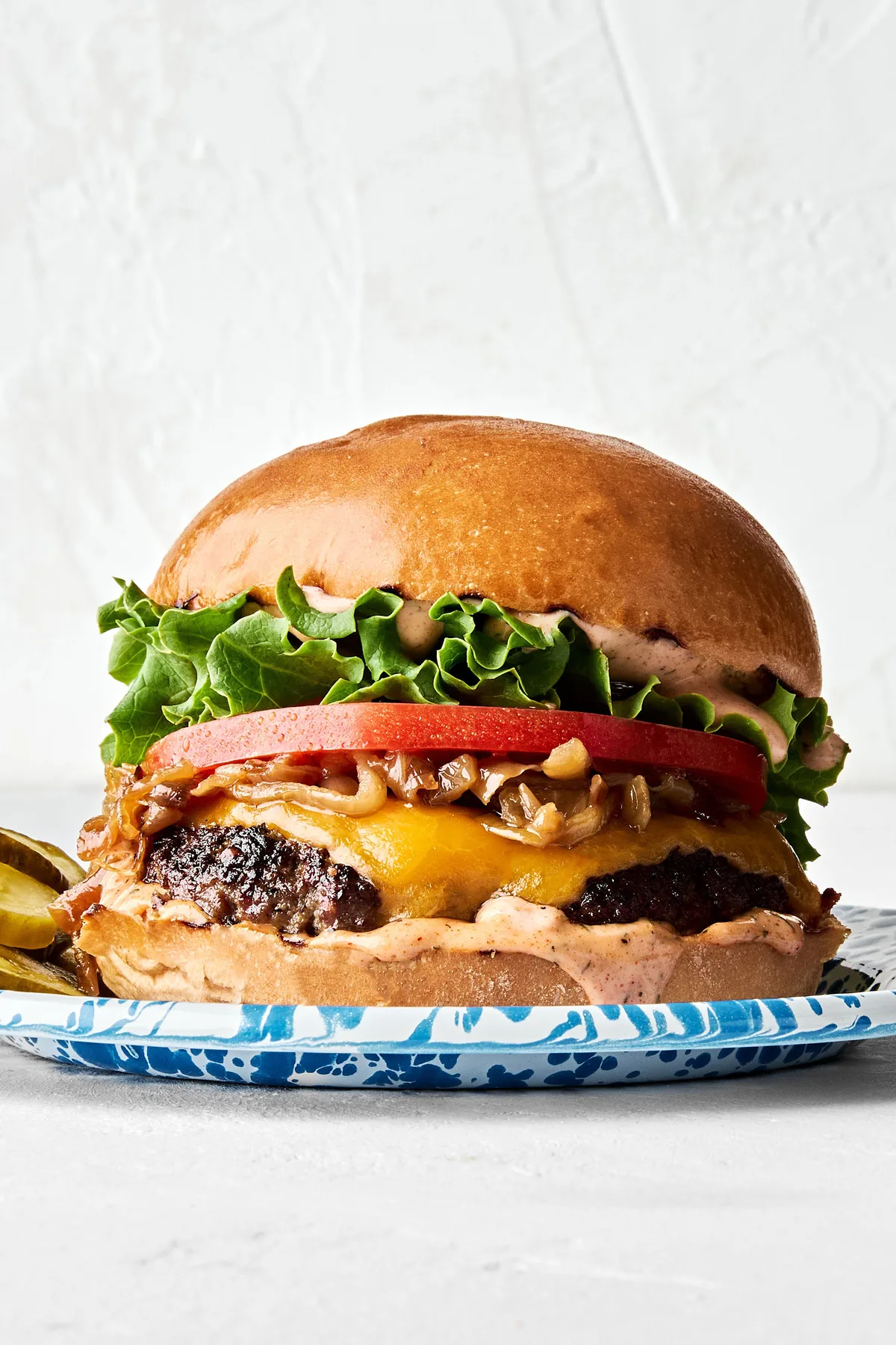 A classic juicy cheese burger topped with secret sauce, melted cheese, caramelized onion, tomato, lettuce and pickles