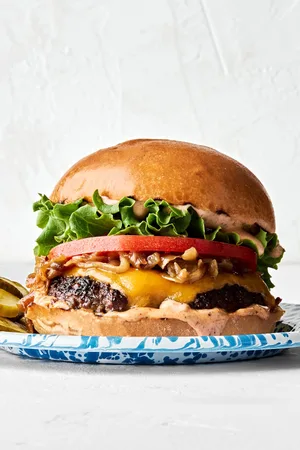 A classic juicy cheese burger topped with secret sauce, melted cheese, caramelized onion, tomato, lettuce and pickles