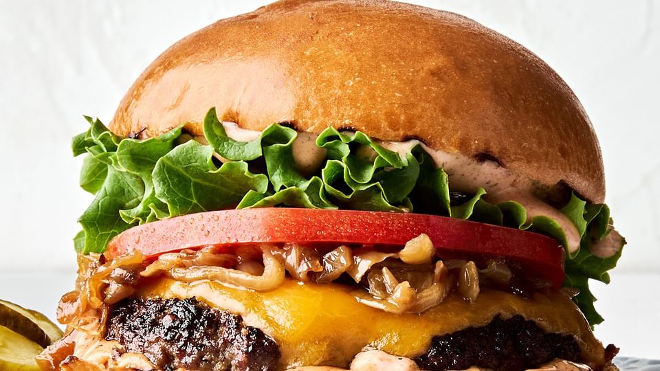 A classic juicy cheese burger topped with secret sauce, melted cheese, caramelized onion, tomato, lettuce and pickles