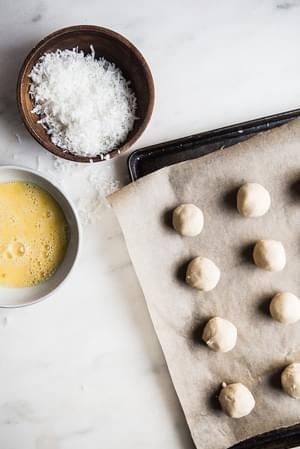 Coconut Thumbprint Cookie dough on a baking sheet