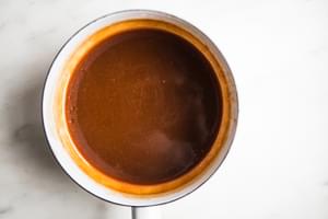 hot caramel in a sauce pan for Coconut Thumbprint Cookies with Salted Caramel