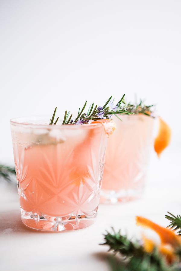2 glasses of Grapefruit Cardamom Gin Fizz with rosemary