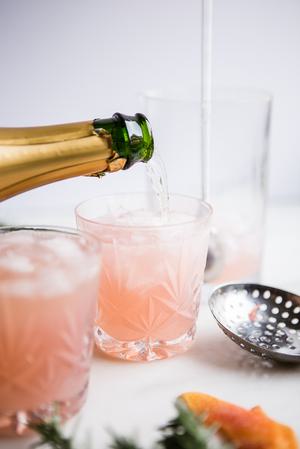 champagne being poured into Grapefruit Cardamom Gin Fizz