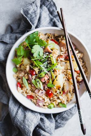 a bowl of Ham and Pineapple Fried Rice with chopsticks