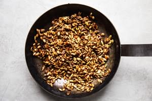 candied Pumpkin Seed Clusters in a saute pan