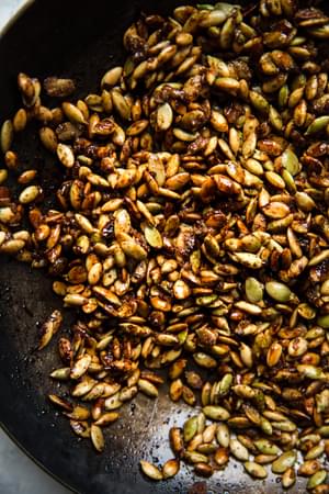 Kale Salad with Pumpkin Seed Clusters in a pan