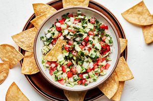 a bowl of fresh homemade pico de gallo served with tortilla chips for serving