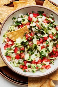 a bowl of fresh homemade pico de gallo served with tortilla chips for serving