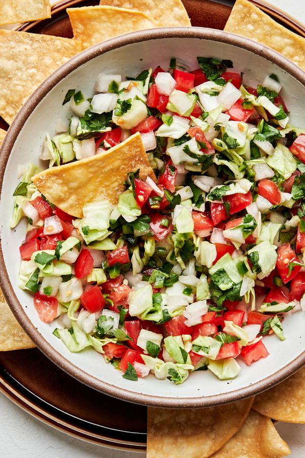 a bowl of fresh homemade pico de gallo served with tortilla chips for serving