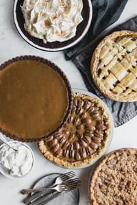 5 Thanksgiving pies on the table: pecan pie, apple pie, pumpkin pie