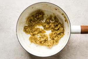 flour and butter clumped together in a small pot to make a roux