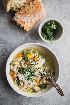 White Bean Chicken Soup in a bowl with a spoon and crusty bread
