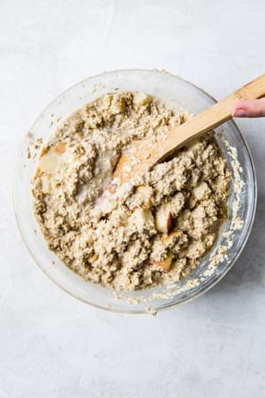 batter for Baked Oatmeal With Apples in a bowl with a wooden spoon