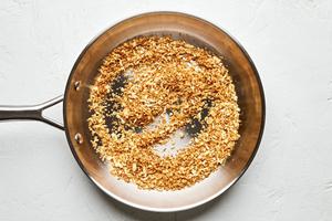 panko being toasted in melted butter in a skillet