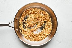 panko being toasted in melted butter in a skillet