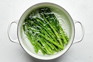 asparagus cooking in a pot of salted boiling water