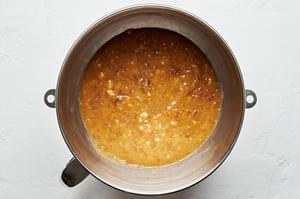butter, brown sugar and eggs being mixed together in a stand mixer