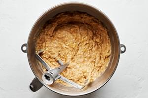 banana bread dough that has been mixed together in a stand mixer with a paddle attachment